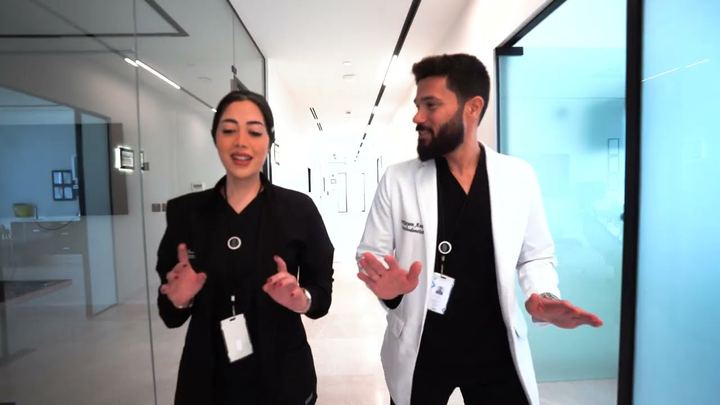 Video thumbnail: a Tam Dental dentist in a white coat and a colleague presenting inside the Jeddah clinic.